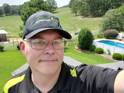 Home Inspector smiling near pool